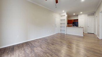 A bedroom with hardwood floors and white walls